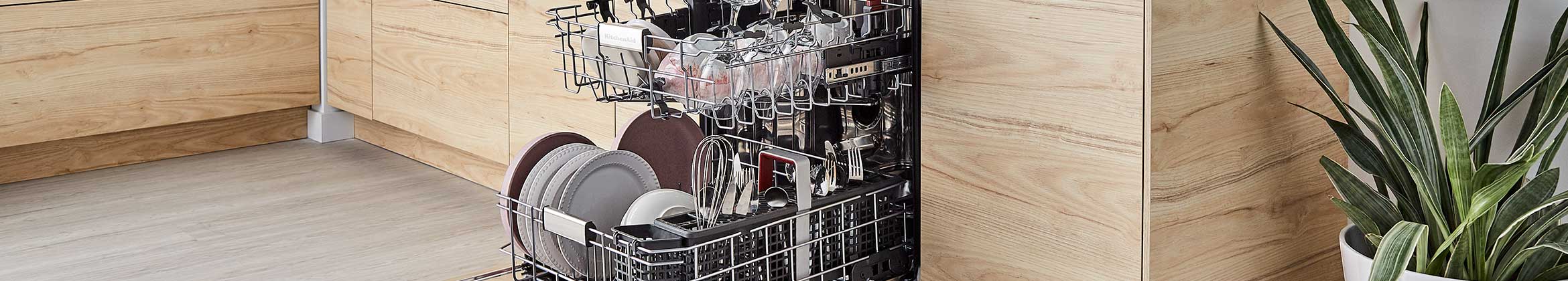 A fully loaded dishwasher with kitchen items