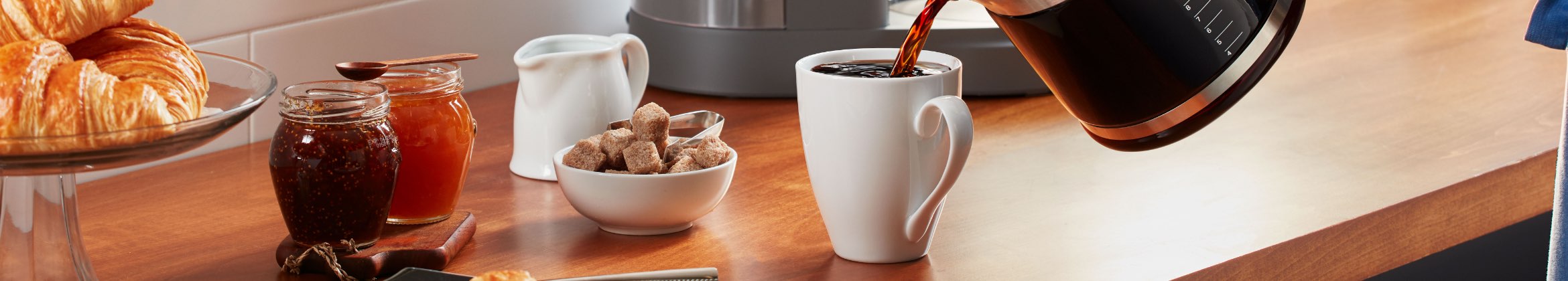 Pouring freshly brewed coffee into cup