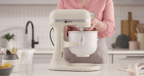 A modern kitchen with dark cabinetry and KitchenAid stainless steel appliances