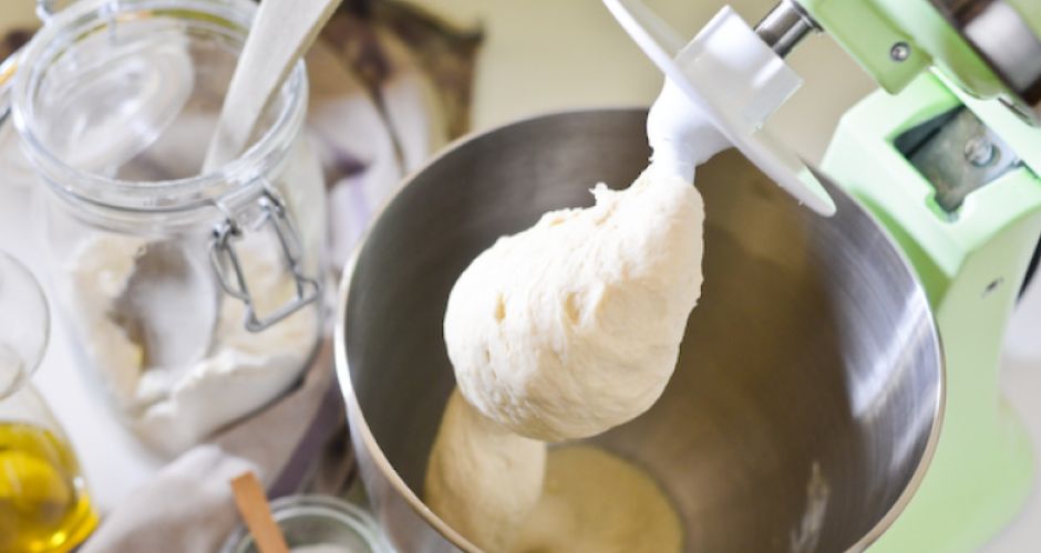 Using a KitchenAid Stand Mixer fitted with a Dough Hook, the dough is elevated from a metal mixing bowl.