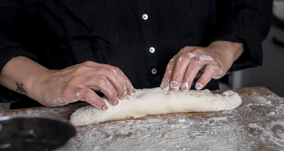 With finesse and precision, skilled hands shape the dough into its desired form.