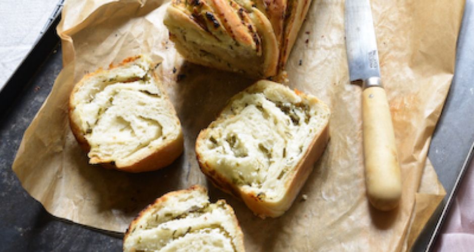 A knife is delicately positioned next to the sliced Babka.