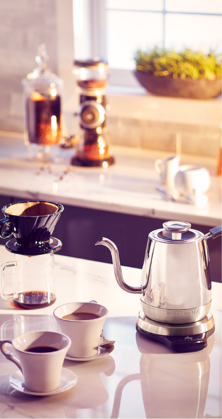 Pour-over coffee setup with multiple cups and a pot.
