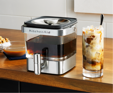 KitchenAid Cold Brew Coffee Maker and a glass of iced coffee on the counter.