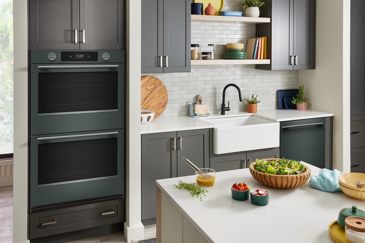 KitchenAid® combo wall oven in a kitchen with gray cabinetry and white countertops