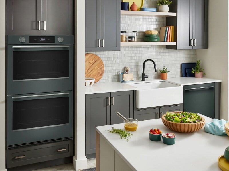 KitchenAid® combo wall oven in a kitchen with juniper cabinetry and white countertops
