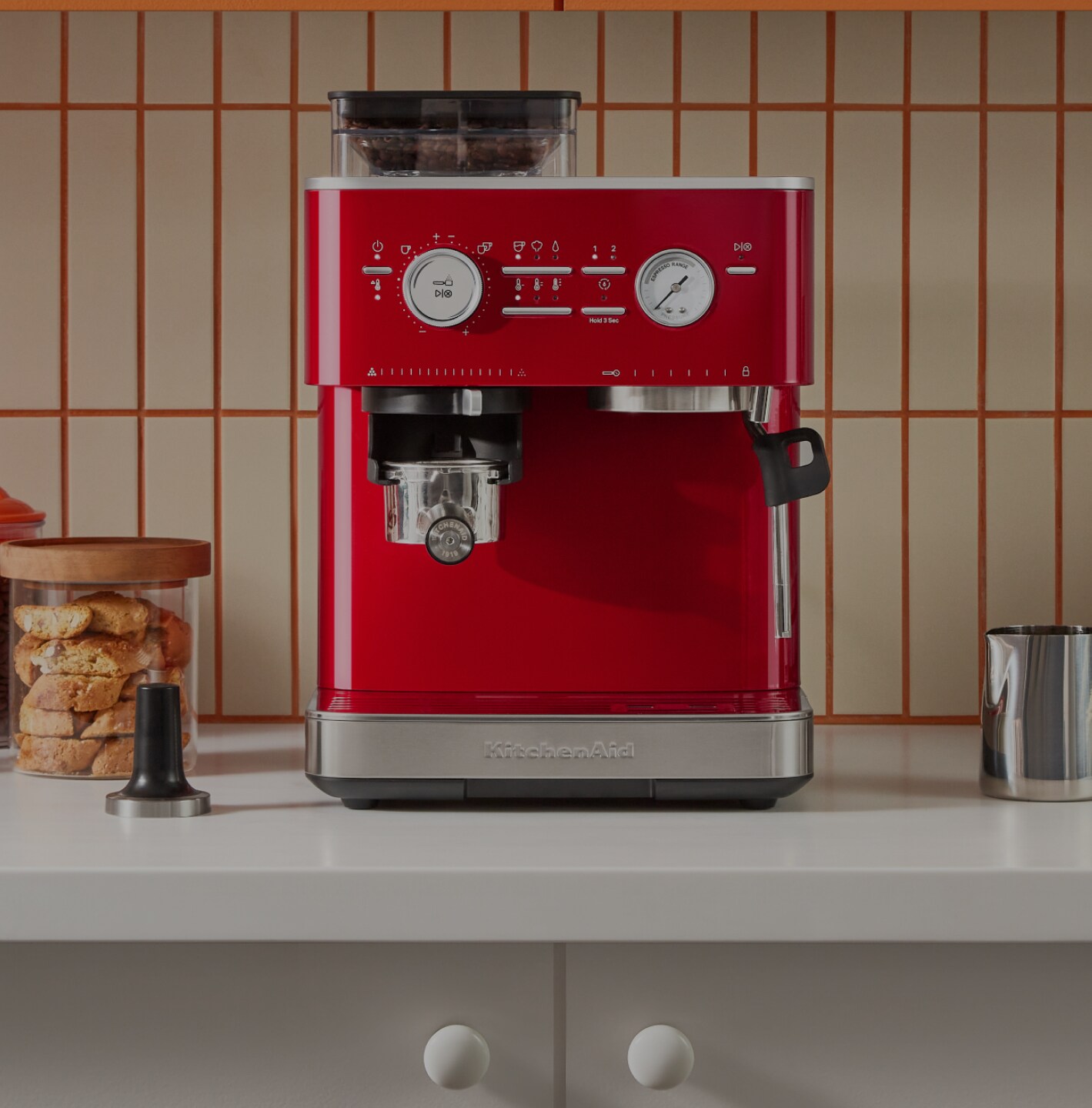 A red espresso machine on a countertop