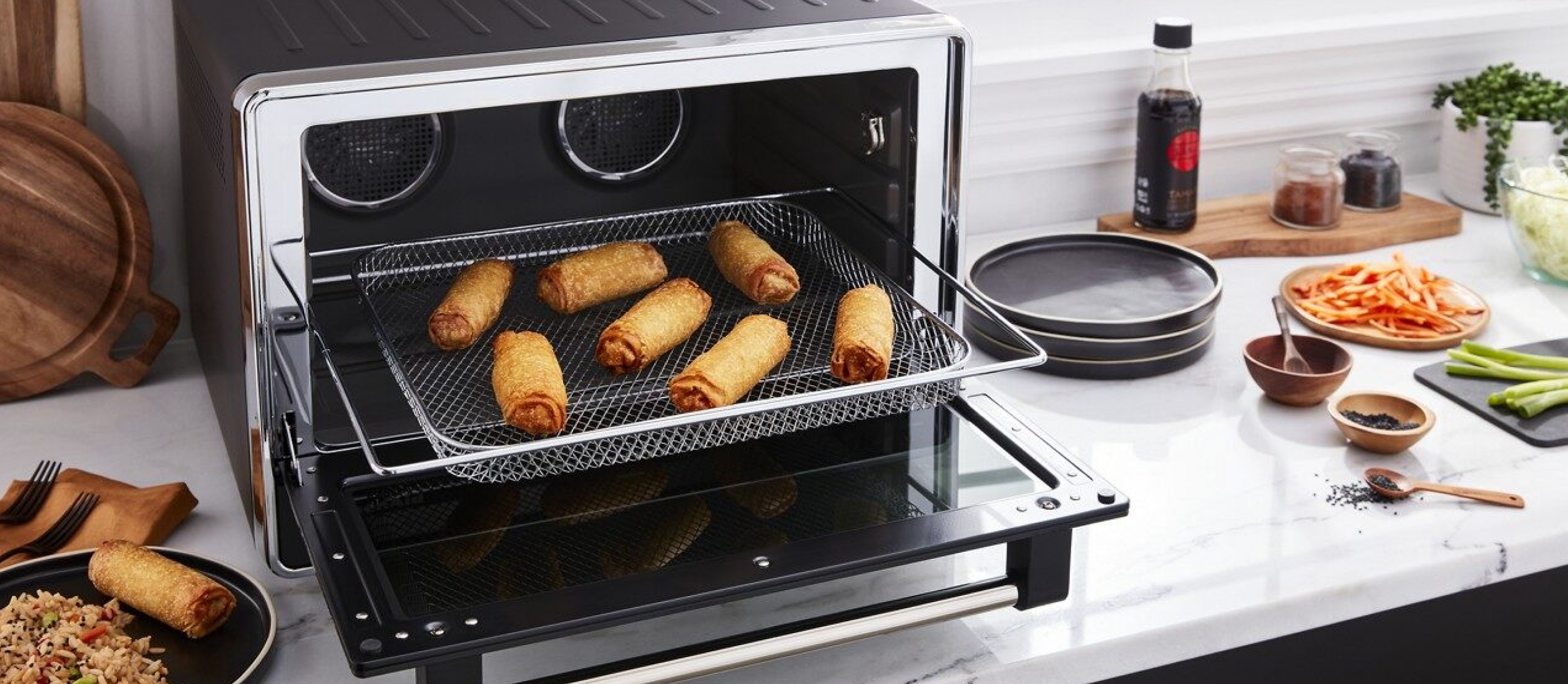 Egg rolls cooking in a KitchenAi® countetop oven.