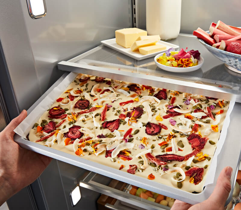 KitchenAid® Built-In Side-by-Side Refrigerator Under-Shelf Prep Zone holding a peach dessert  