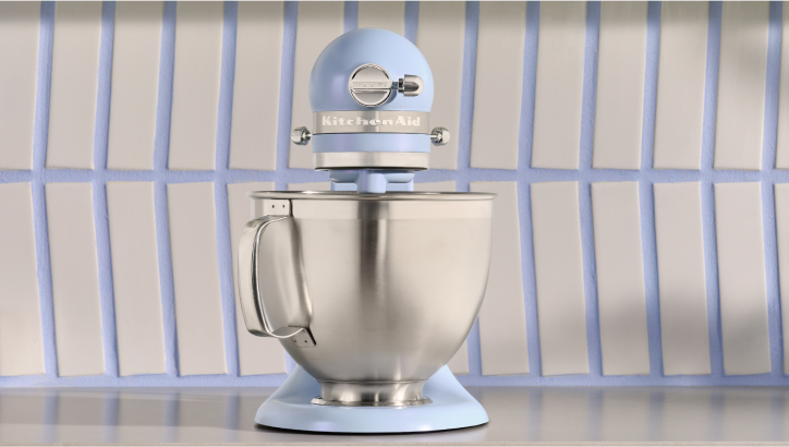 A front-facing Blue Salt stand mixer against a colour-coordinating backsplash.