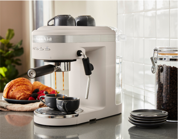 A KitchenAid® Espresso Machine in Milkshake in a white contemporary kitchen.