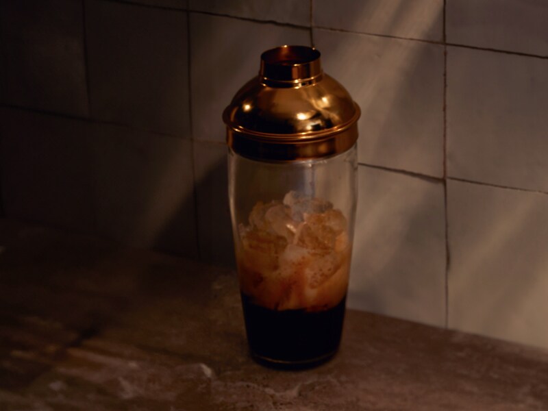  A martini shaker filled with ice and espresso.