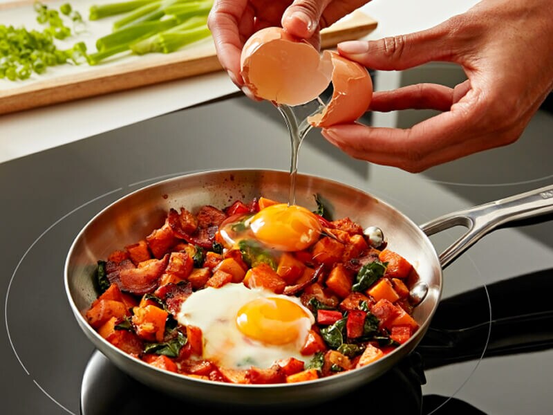 Une personne cuisine sur une table de cuisson à induction