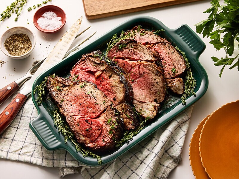 Herb-seasoned meat in a casserole pan