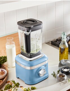 An Evergreen stand mixer sitting on a countertop.