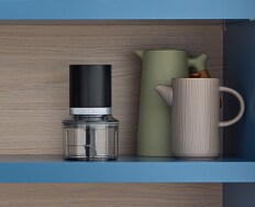 A KitchenAid® Grain and Rice Cooker on a white countertop, behind it a green backsplash.
