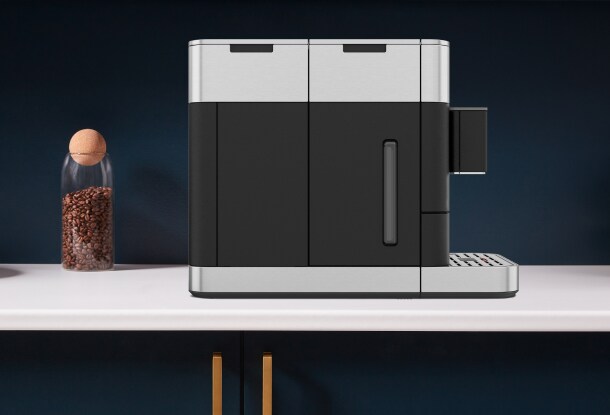 Person changing the filter of a KitchenAid® Fully Automatic Espresso Machine