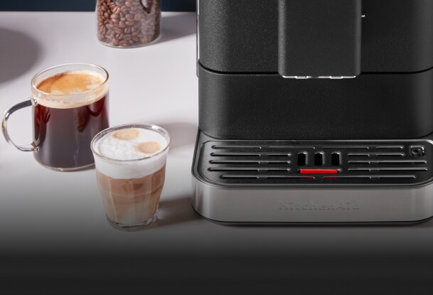 Two espresso drinks next to a KitchenAid® espresso machine