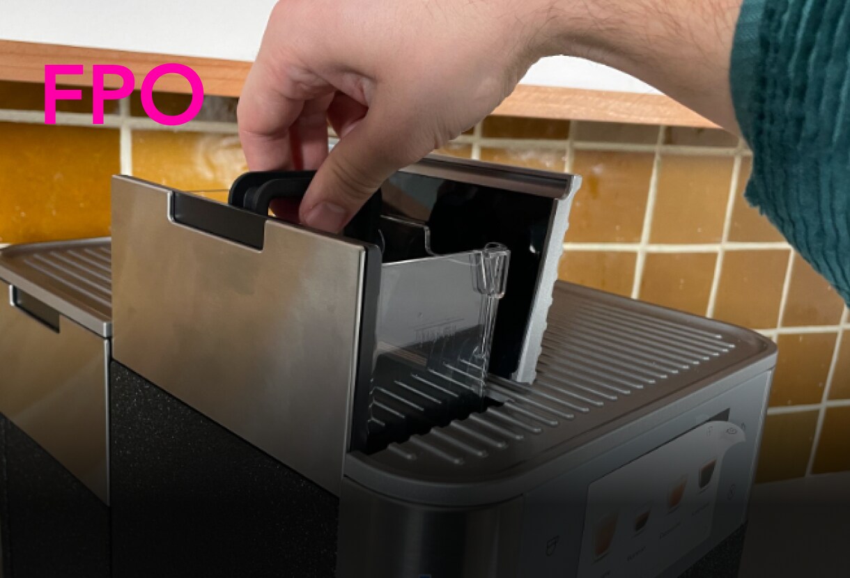 Person changing the filter of a KitchenAid® Fully Automatic Espresso Machine