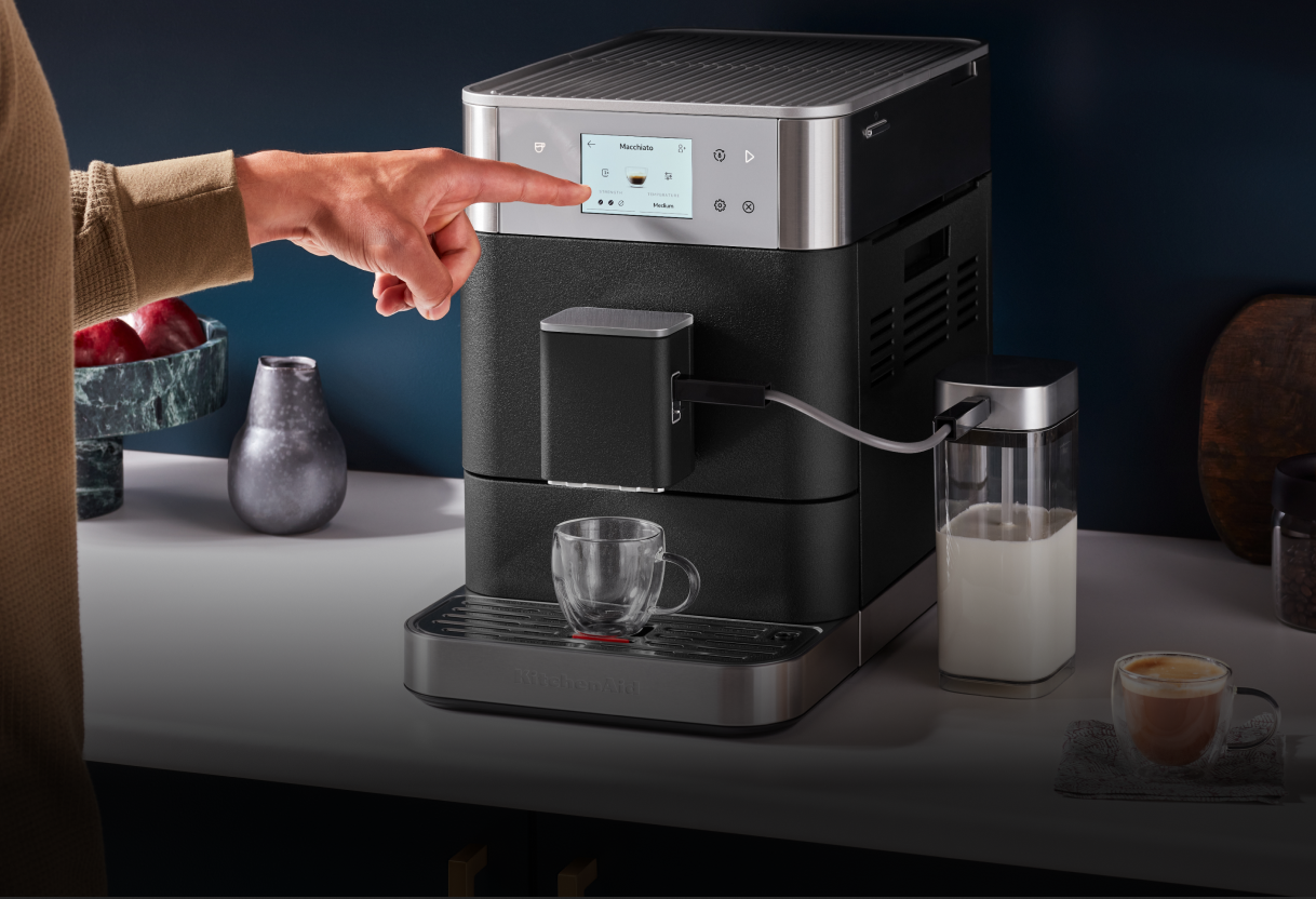 Person selecting a setting on a KitchenAid® Fully Automatic Espresso Machine