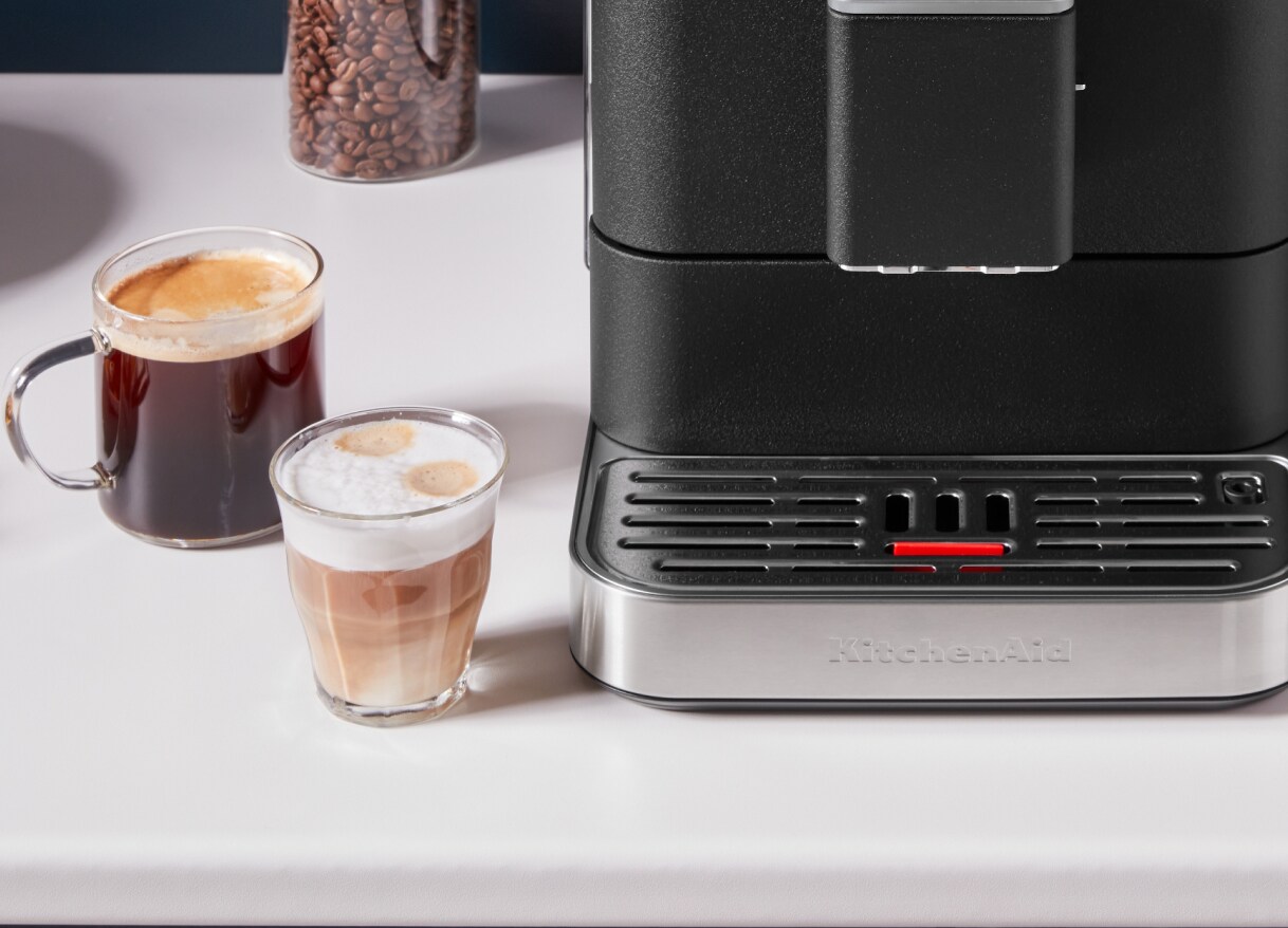 Two espresso drinks next to a KitchenAid® espresso machine