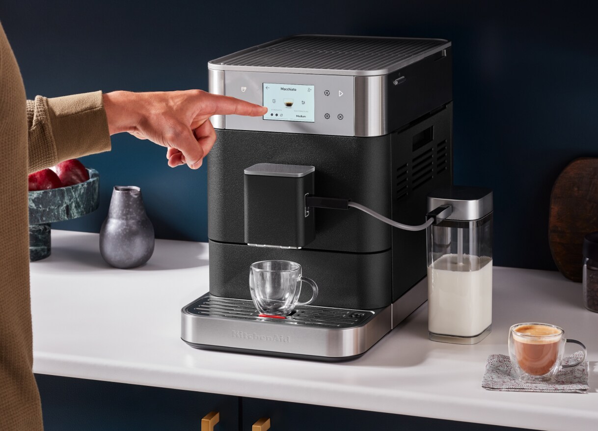 Person selecting a setting on a KitchenAid® Fully Automatic Espresso Machine
