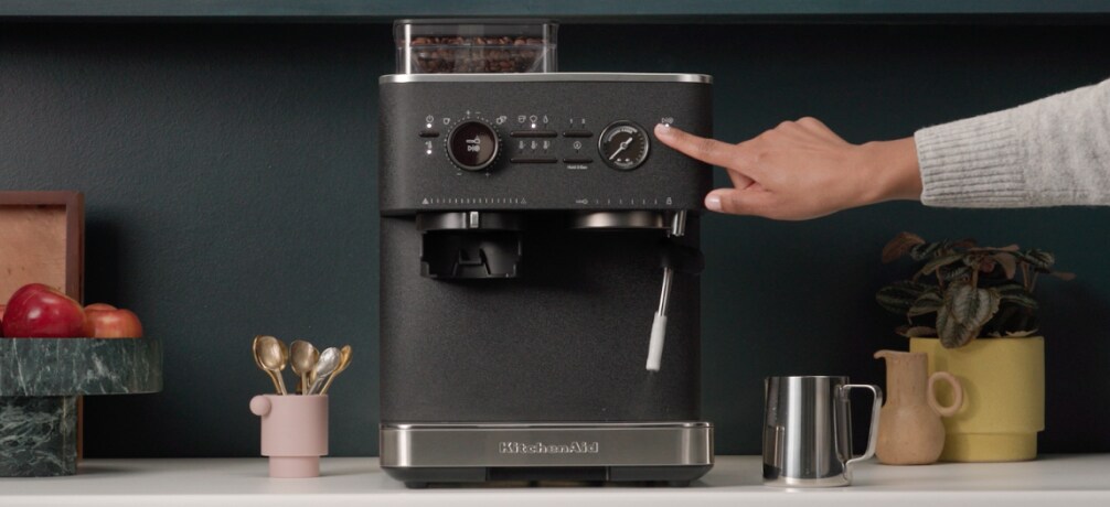 Person using an espresso machine steam wand
