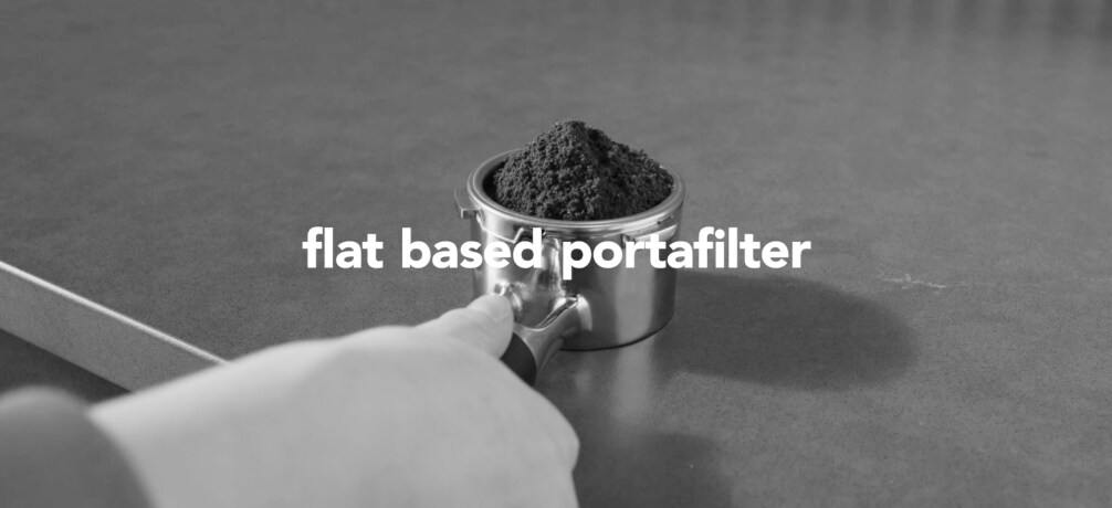 Person removing the bean hopper from an espresso maker