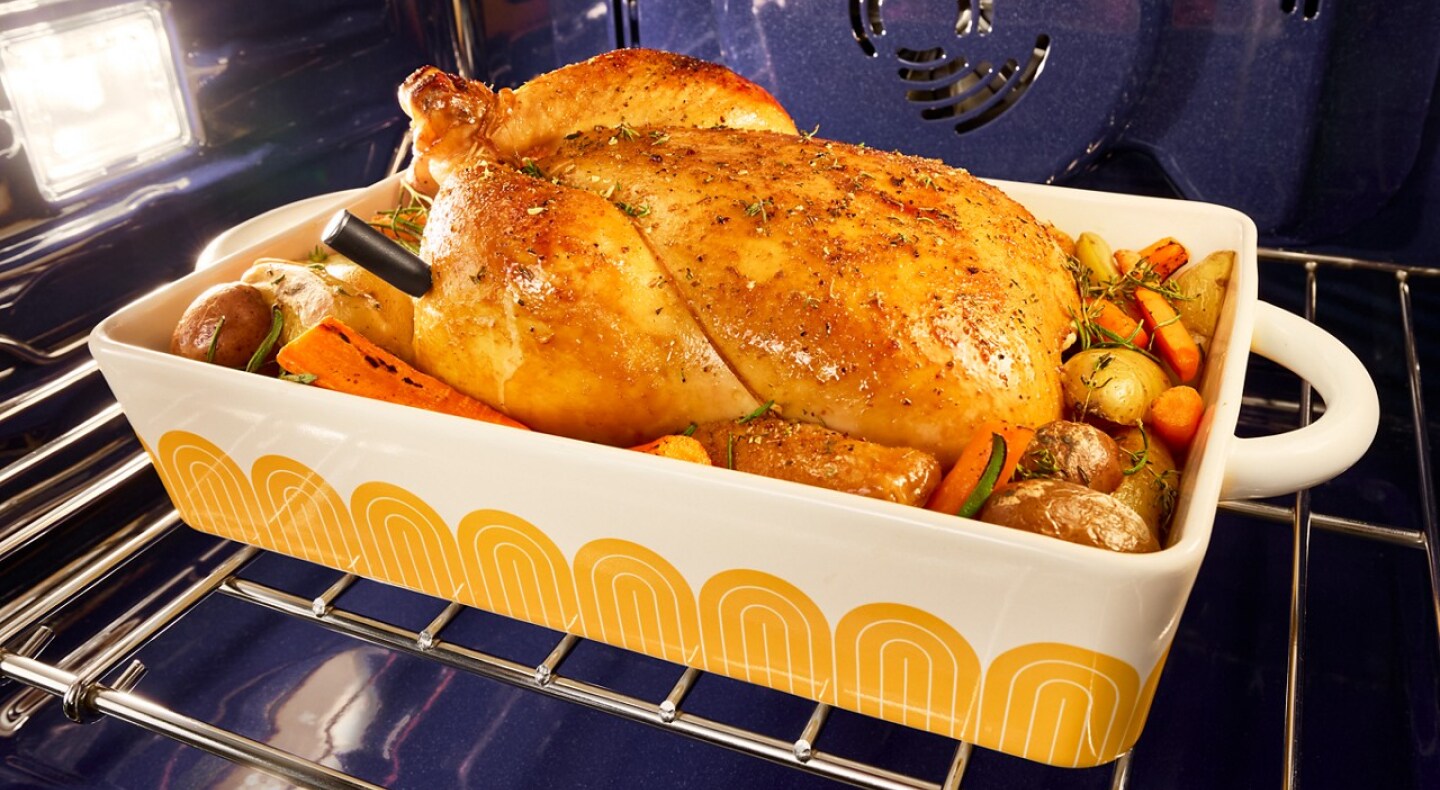 A cooked turkey and vegetables in a KitchenAid® wall oven