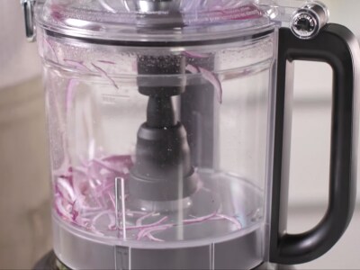Chopping onions whirring in a food processor.