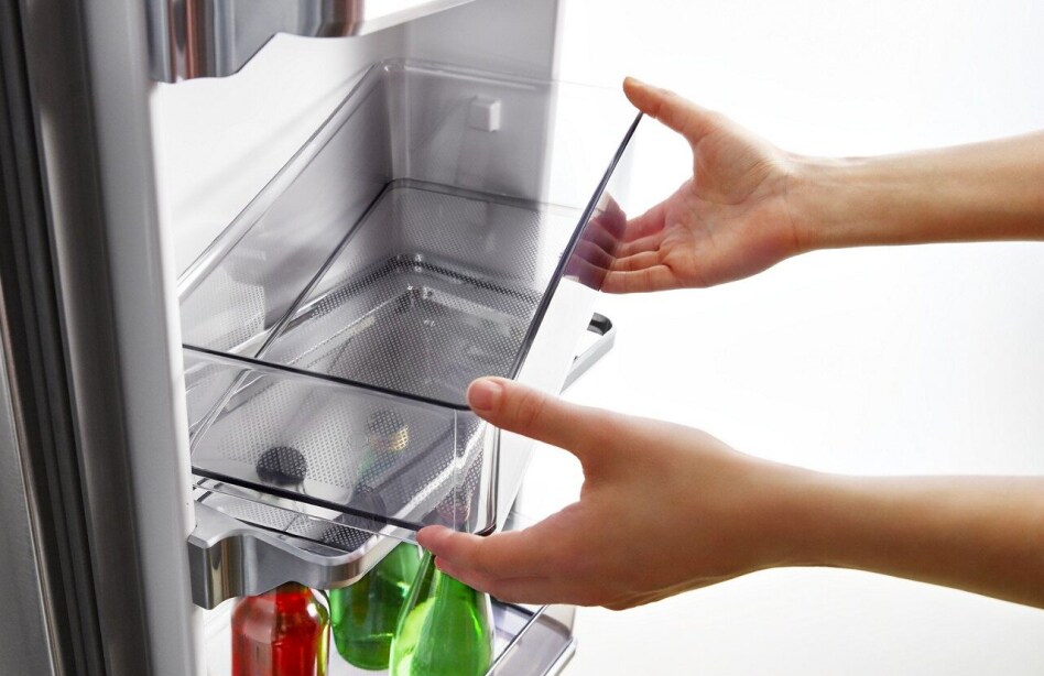 Person removing refrigerator door bin
