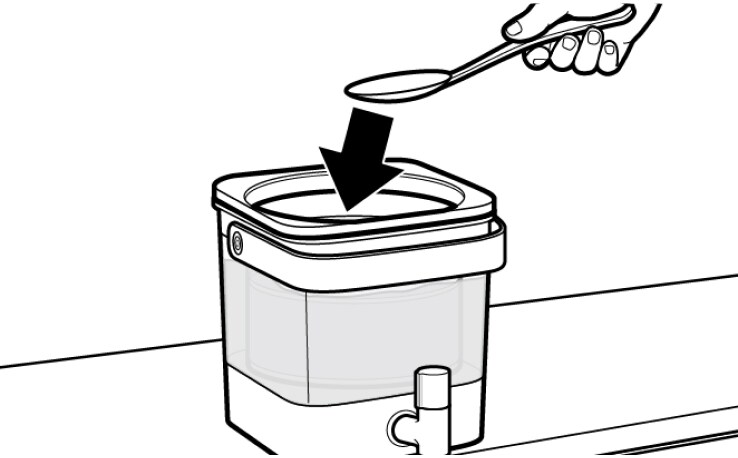 Hand using spoon to submerge cold brew coffee grounds in water