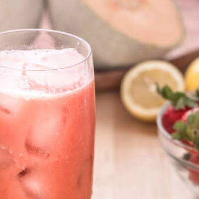 Blended strawberry juice in a glass with ice