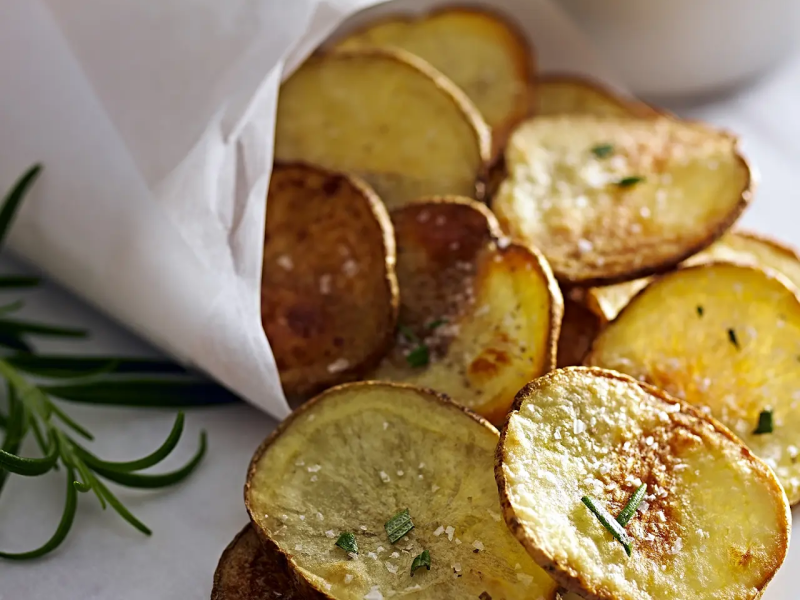 Homemade potato chips garnished with chives
