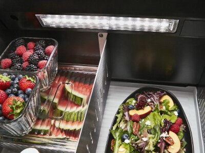 Fresh produce inside a refrigerator with LED lighting