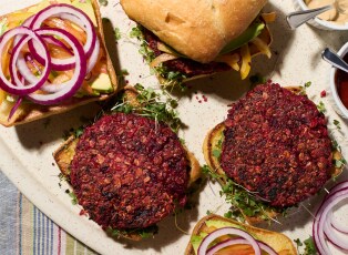A plate of assembled and partially-assembeled black bean burgers.