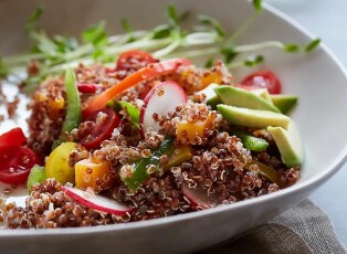 A colourful couscous based salad with cucumber, red onion and tomato.