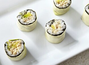 A serving platter filled with various types of sushi rolls.