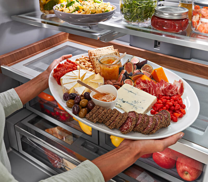 KitchenAid® French Door Bottom Mount Refrigerator Under-Shelf Prep Zone holding charcuterie board.