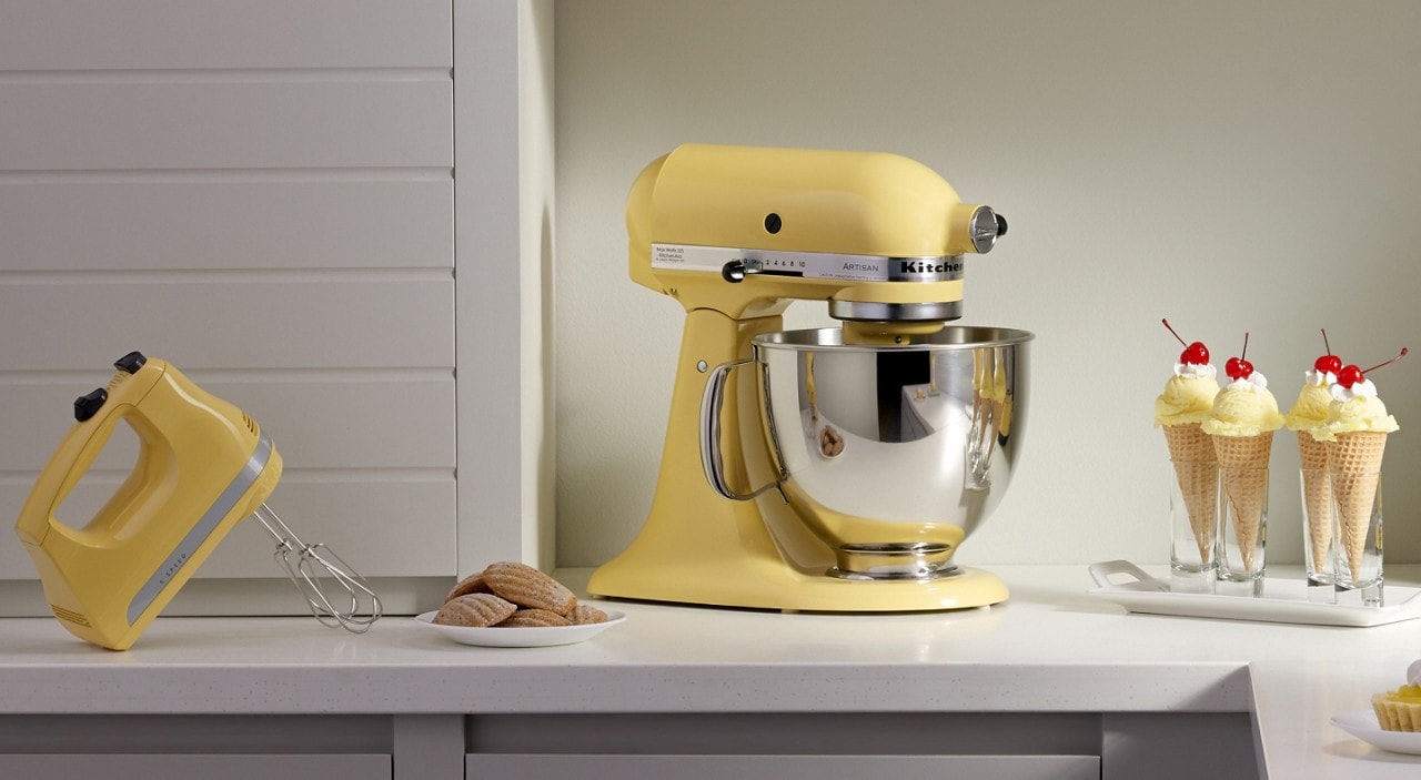 Buttermilk yellow stand mixer and hand mixer on counter with ice cream cones