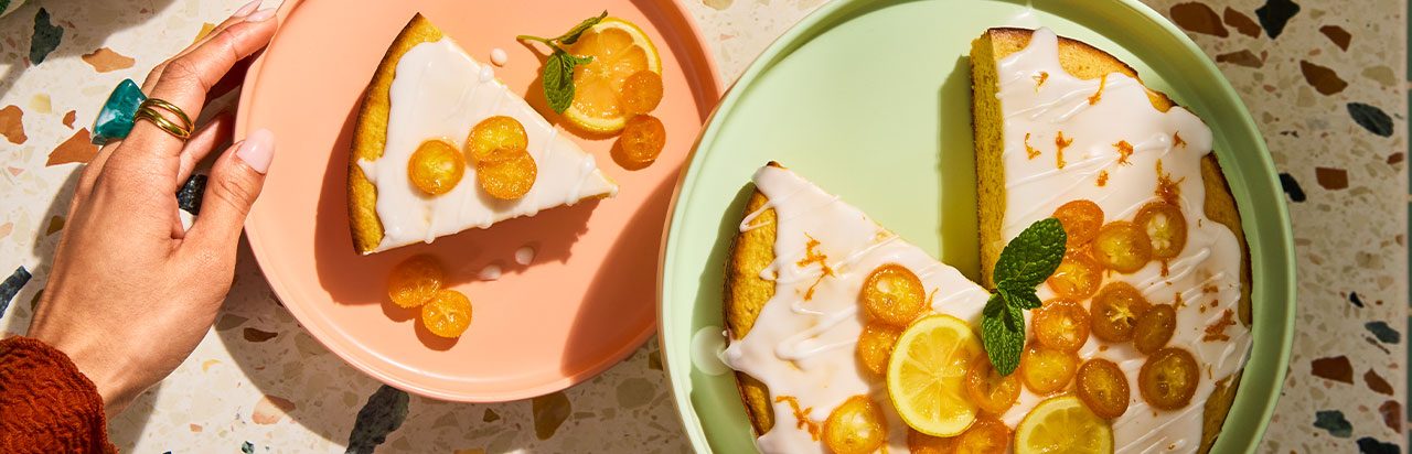 A scone on a napkin with a small container of herb butter. 