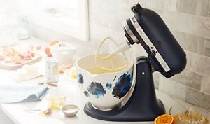 Light blue tilt-head Stand Mixer with white and blue flower-patterned ceramic bowl.