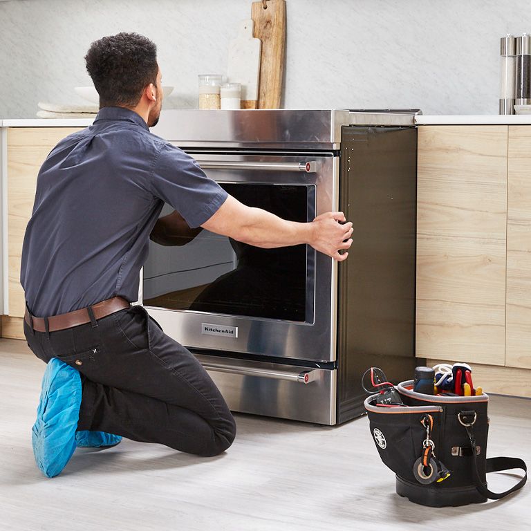 Appliance repair professional consulting with a home owner 