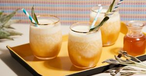 A Kyoto Glow blender filled with sliced mangos and yogurt surrounded by citruses and granola.