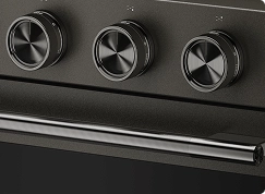 A close up on the handle and knobs of a Black Ore range.