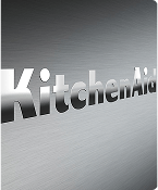 A close up of the embossed KitchenAid brand logo on the stainless steel range.