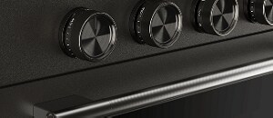A close-up on the handle and knobs of a Black Ore range.