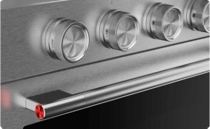 A close-up on the handles and knobs of a Stainless Steel range.