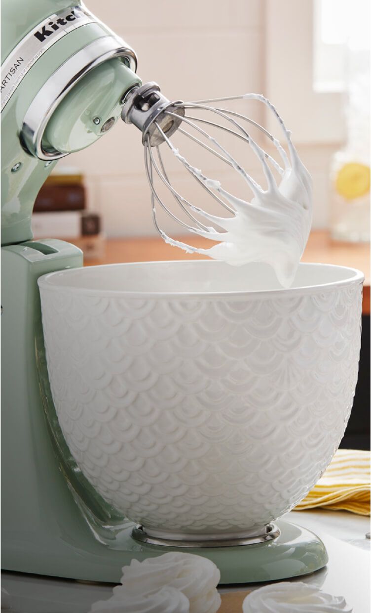 Light-green Stand Mixer tilted up after whipping cream.