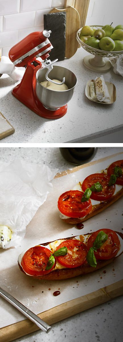 Red Stand Mixer with dough hook attached, and stainless steel bowl with dough in it, with a plate with tomatoes and mozzarella cheese on toast.
